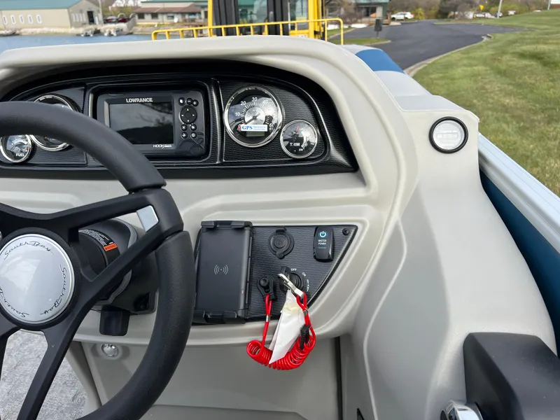 Slide: The Image of 2025 South Bay 222 CR2 LE boat dashboard with steering wheel and control panel. - 18