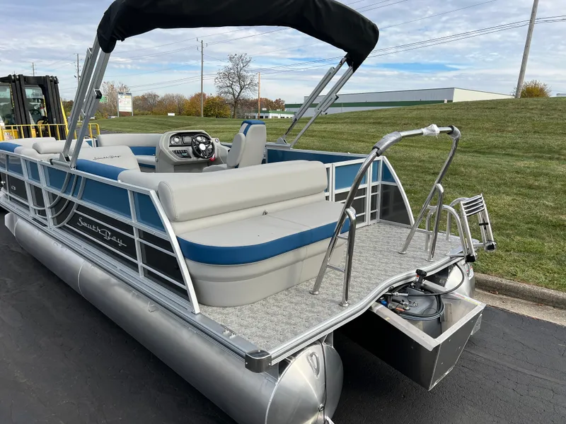 Slide: The Image of 2025 South Bay 222 CR2 LE pontoon boat with blue accents and seating. - 6