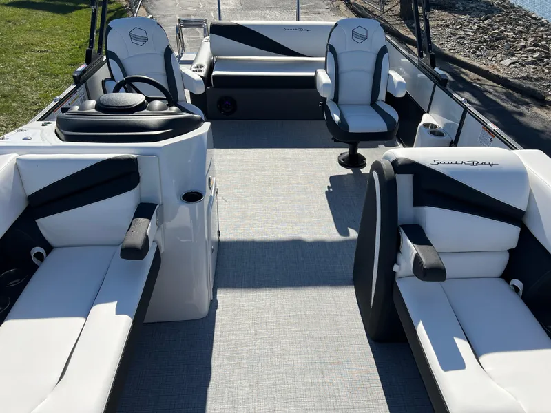 Slide: The Image of 2025 South Bay S 224 UL pontoon boat interior with white and black seating. - 10