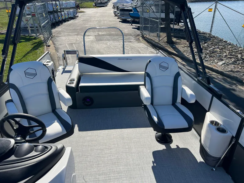 Slide: The Image of 2025 South Bay S 224 UL pontoon boat interior with seating and steering wheel. - 11