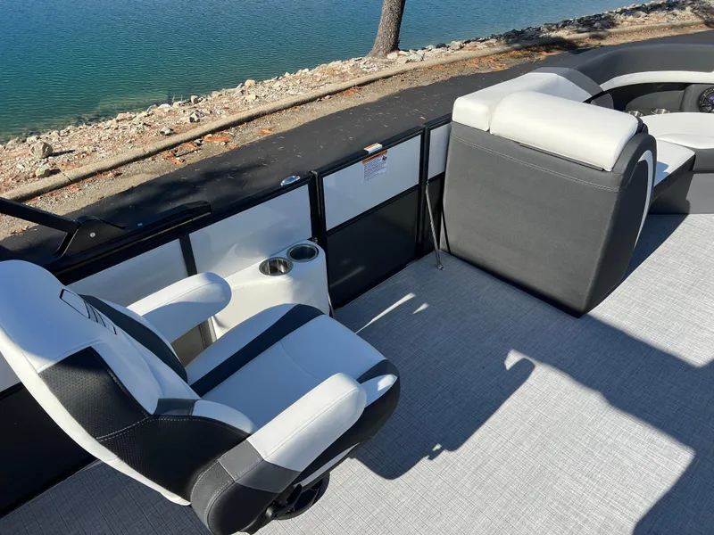 Slide: The Image of 2025 South Bay S 224 UL boat interior with seating, near a calm waterfront. - 19