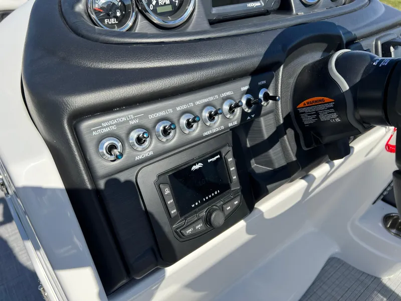 Slide: The Image of Control panel of 2025 South Bay S 224 UL boat with switches and gauges. - 21