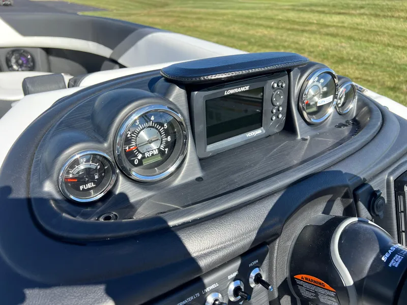 Slide: The Image of Dashboard of 2025 South Bay S 224 UL boat with gauges and Lowrance display. - 22