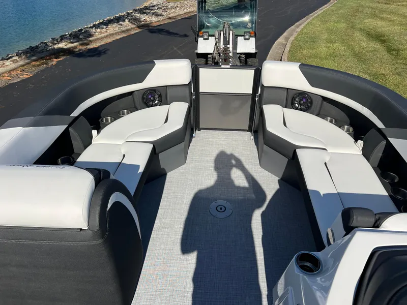 Slide: The Image of 2025 South Bay S 224 UL pontoon boat interior with seating, near water. - 24