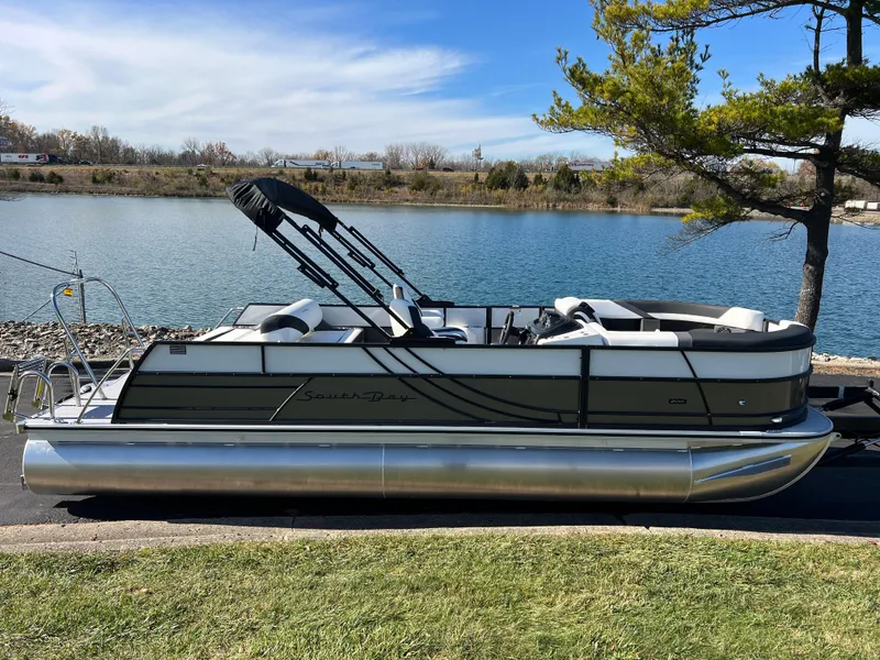 Slide: The Image of 2025 South Bay S 224 UL pontoon boat by a serene lake. - 3