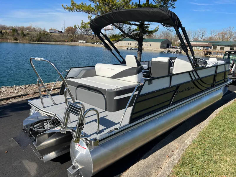 Slide: The Image of 2025 South Bay S 224 UL pontoon boat docked by a serene lake. - 4