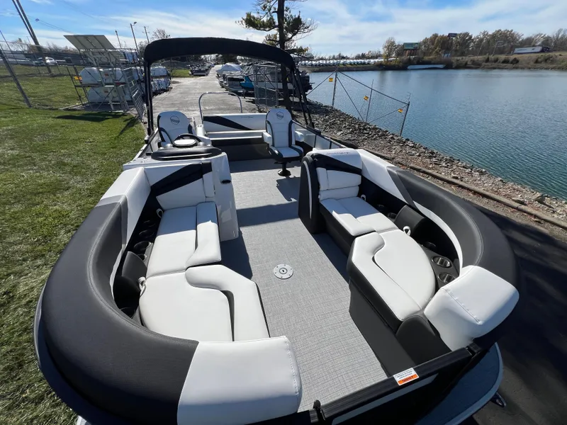 Slide: The Image of 2025 South Bay S 224 UL pontoon boat with spacious seating by the water. - 7