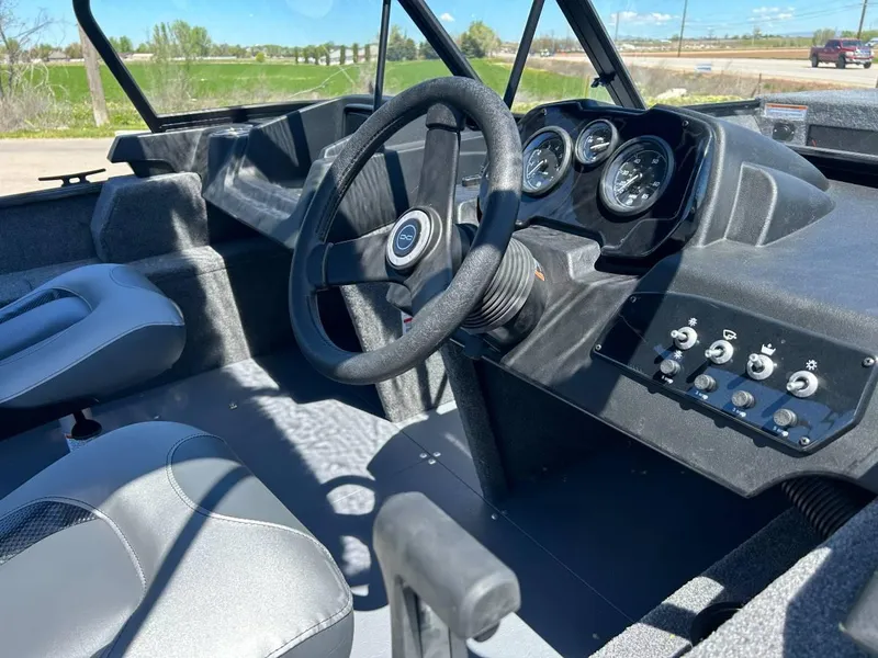 Slide: The Image of 2024 Princecraft Holiday 162 WS MAX boat interior with steering wheel and dashboard controls. - 4