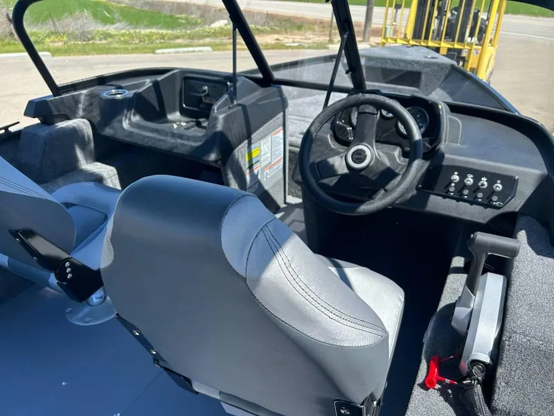 Slide: The Image of 2024 Princecraft Holiday 162 WS MAX boat interior with steering wheel and seating. - 5