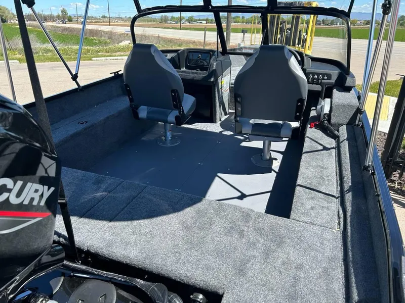 Slide: The Image of 2024 Princecraft Holiday 162 WS MAX boat interior with seating and Mercury engine. - 6