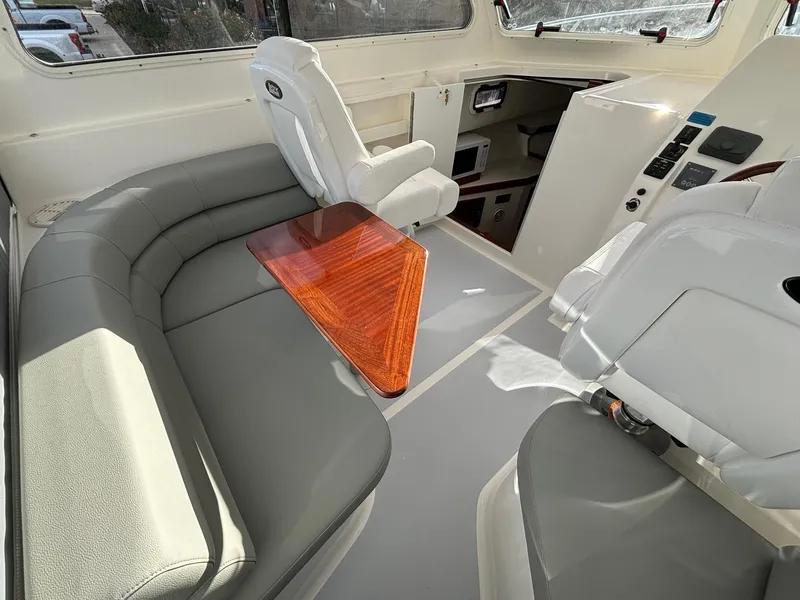 Slide: The Image of 2025 NorthCoast 285 Cabin interior with seating and wooden table. - 18