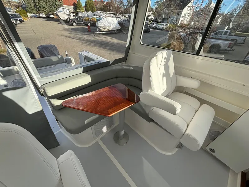 Slide: The Image of 2025 NorthCoast 285 Cabin interior with seating and table, showcasing modern design. - 19