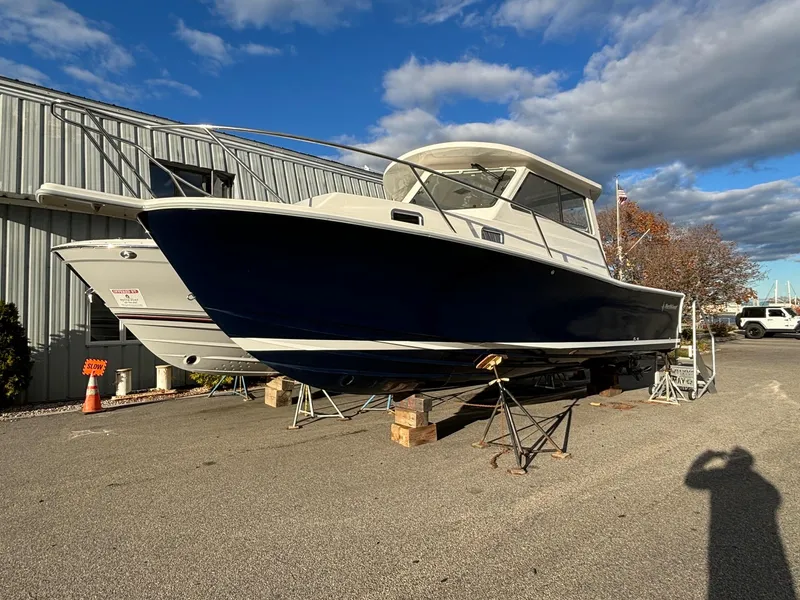 Slide: The Image of 2025 NorthCoast 285 Cabin boat on dry dock under a clear sky. - 2
