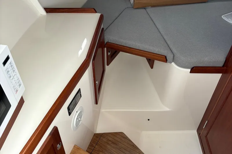 Slide: The Image of 2025 NorthCoast 285 Cabin interior with wood accents and cozy seating area. - 21