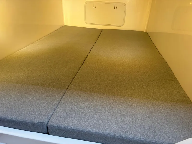 Slide: The Image of 2025 NorthCoast 285 Cabin interior with comfortable gray bedding. - 23