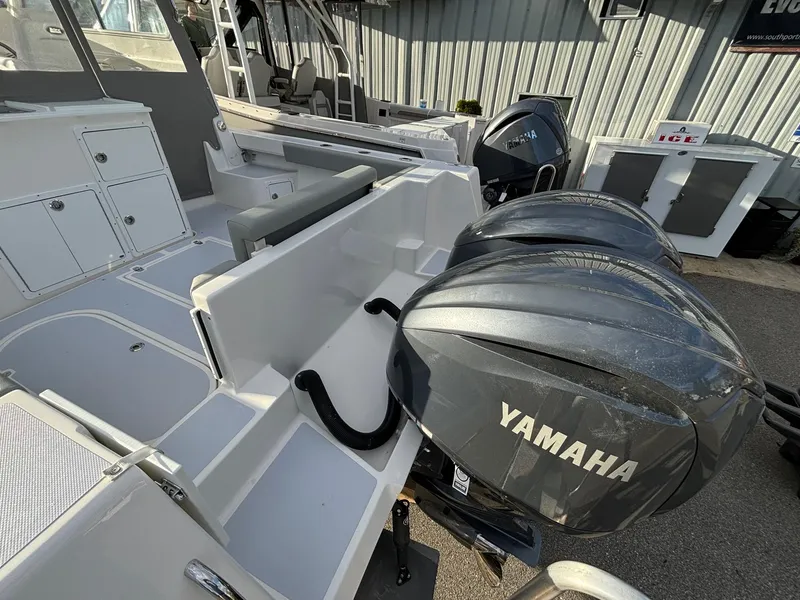 Slide: The Image of 2025 NorthCoast 285 Cabin boat with Yamaha outboard engines, docked at a marina. - 4