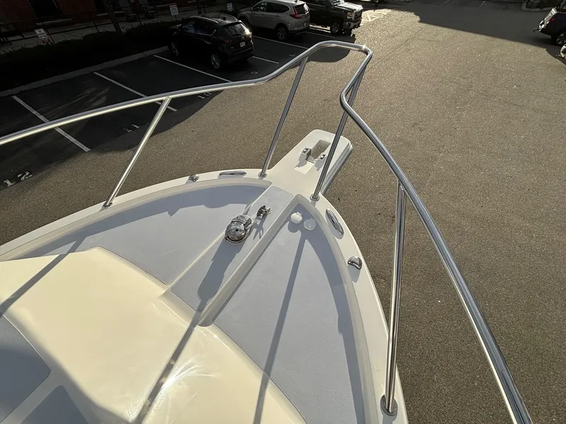 Slide: The Image of 2025 NorthCoast 285 Cabin boat deck with railing in a parking lot. - 5