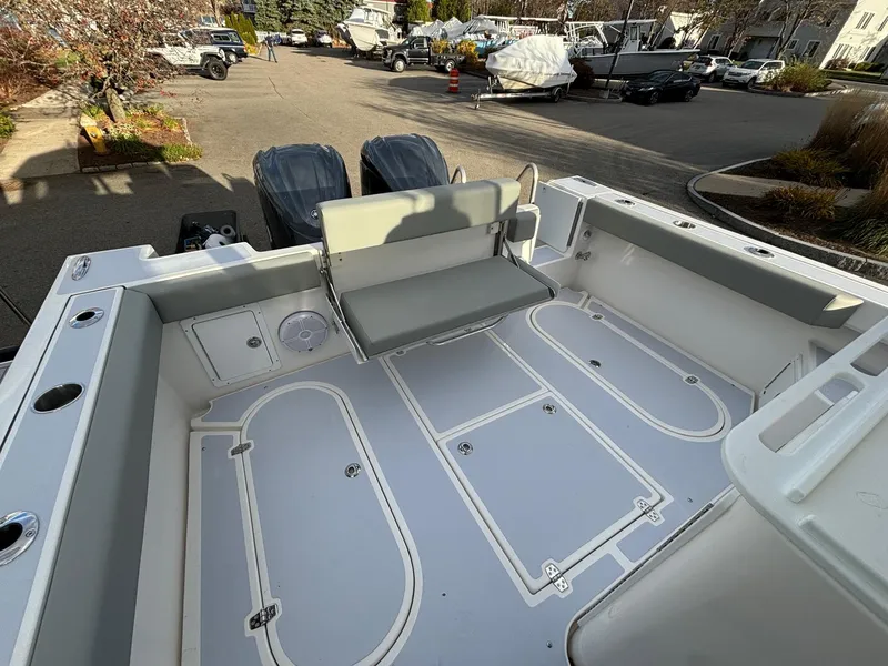 Slide: The Image of 2025 NorthCoast 285 Cabin boat deck with seating and dual engines. - 7