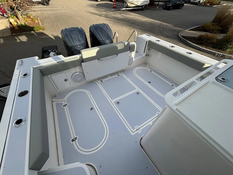 Slide: The Image of 2025 NorthCoast 285 Cabin boat deck with dual engines, spacious seating, and modern design. - 9