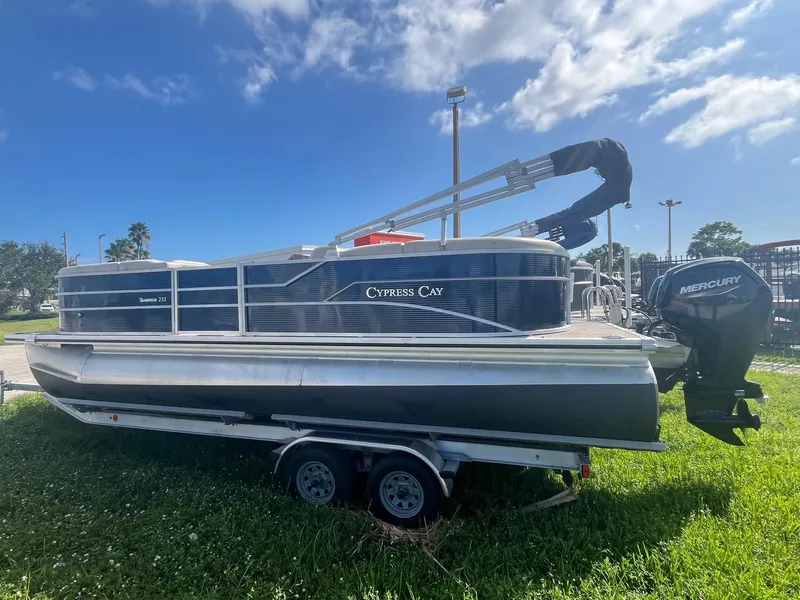 The Image of 2022 Cypress Cay Seabreeze 232 pontoon boat on grass with Mercury outboard motor. - 0