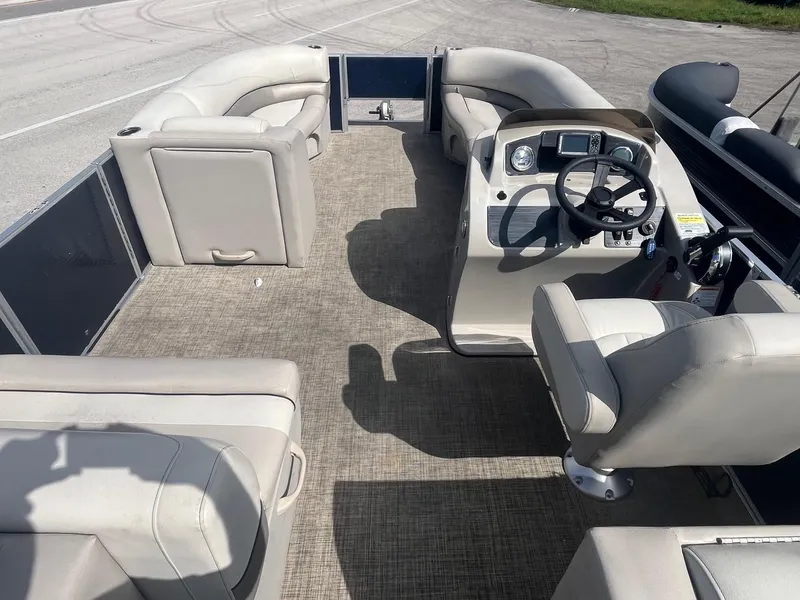 Slide: The Image of 2022 Cypress Cay Seabreeze 232 pontoon boat interior with beige seating and steering console. - 4