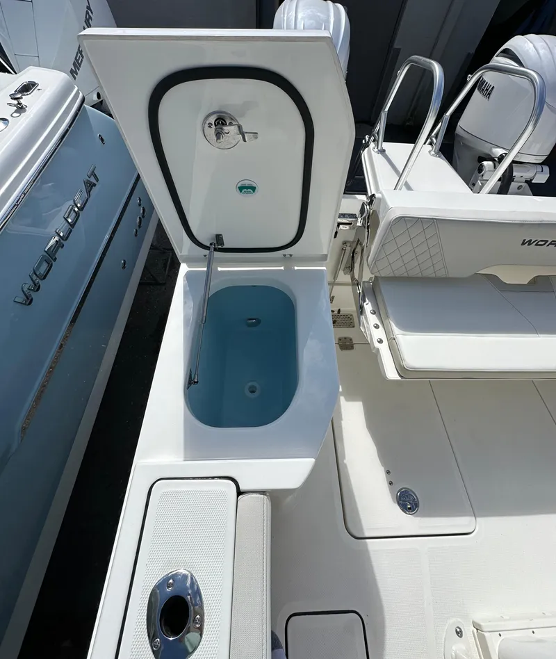 Slide: The Image of 2025 World Cat 260 CC-X boat with open storage compartment and seating area. - 14