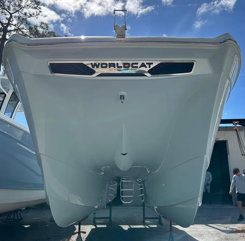 Slide: The Image of 2025 World Cat 260 CC-X boat hull, viewed from below, under a clear blue sky. - 19