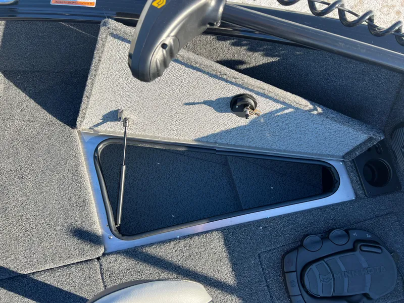 Slide: The Image of 2025 Lund 1775 Impact XS Sport boat interior with open storage compartment. - 10