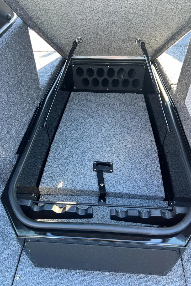 Slide: The Image of 2025 Lund 1775 Impact XS Sport boat storage compartment with rod holders. - 11