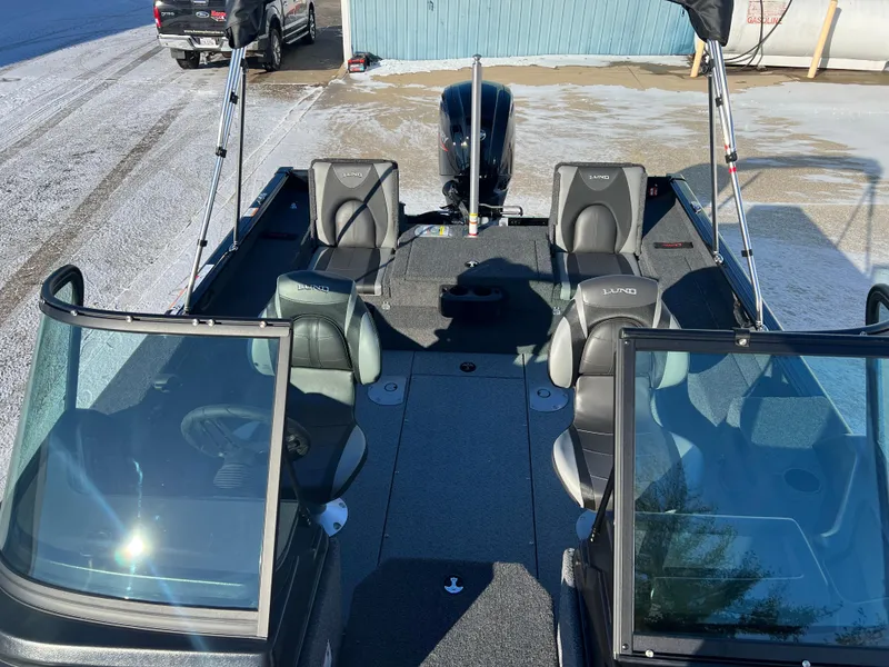 Slide: The Image of 2025 Lund 1775 Impact XS Sport boat interior with seating and windshield. - 12