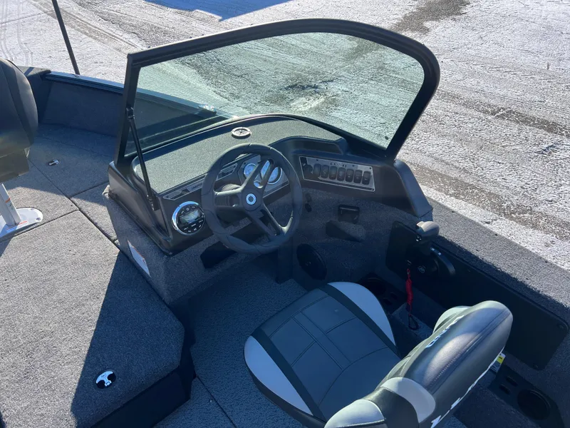Slide: The Image of 2025 Lund 1775 Impact XS Sport boat interior with steering wheel and seating. - 14