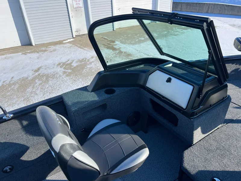 Slide: The Image of 2025 Lund 1775 Impact XS Sport boat interior with seating and windshield. - 17