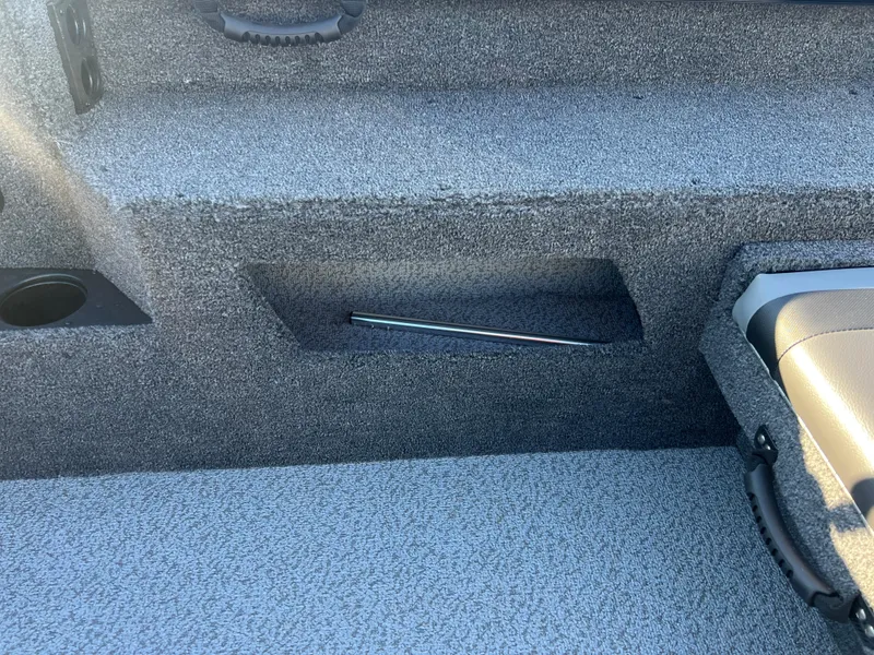 Slide: The Image of 2025 Lund 1775 Impact XS Sport boat interior with storage compartment and seating. - 20