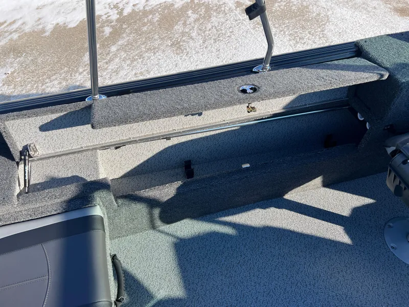 Slide: The Image of 2025 Lund 1775 Impact XS Sport boat interior with seating and storage compartments. - 21