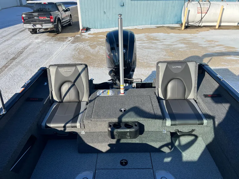 Slide: The Image of 2025 Lund 1775 Impact XS Sport boat interior with seating and motor. - 22