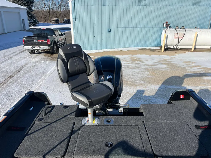 Slide: The Image of 2025 Lund 1775 Impact XS Sport boat with swivel seat on snowy day. - 23
