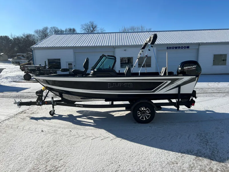 Slide: The Image of 2025 Lund 1775 Impact XS Sport boat in snowy showroom setting. - 3