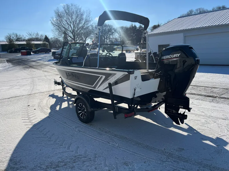 Slide: The Image of 2025 Lund 1775 Impact XS Sport boat on snowy ground, featuring Mercury outboard motor. - 4