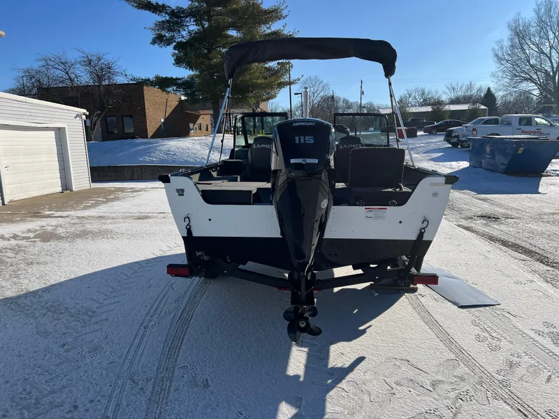 Slide: The Image of 2025 Lund 1775 Impact XS Sport boat on snowy driveway, rear view. - 5