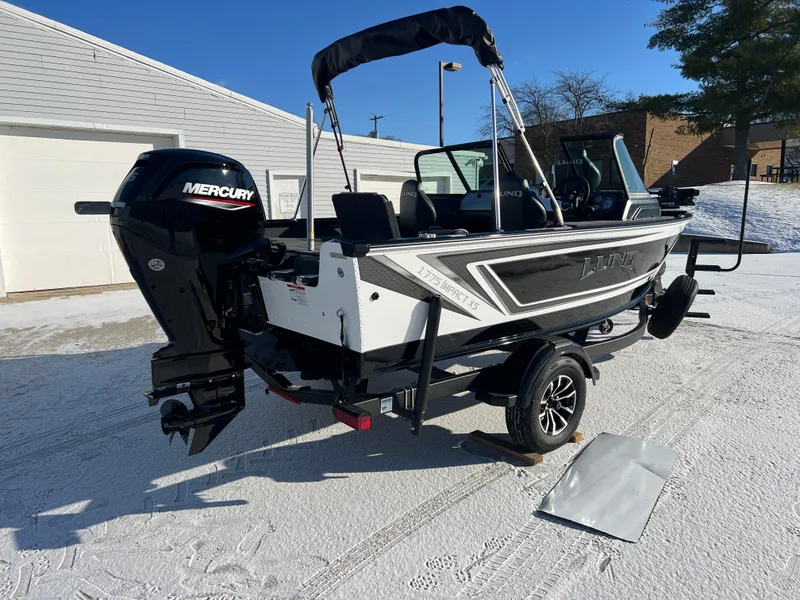 Slide: The Image of 2025 Lund 1775 Impact XS Sport boat with Mercury engine on snowy ground. - 6