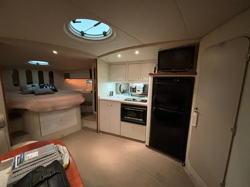 Slide: The Image of Interior of 1998 Cruisers Yachts 3870 Esprit with kitchenette and cozy sleeping area. - 13