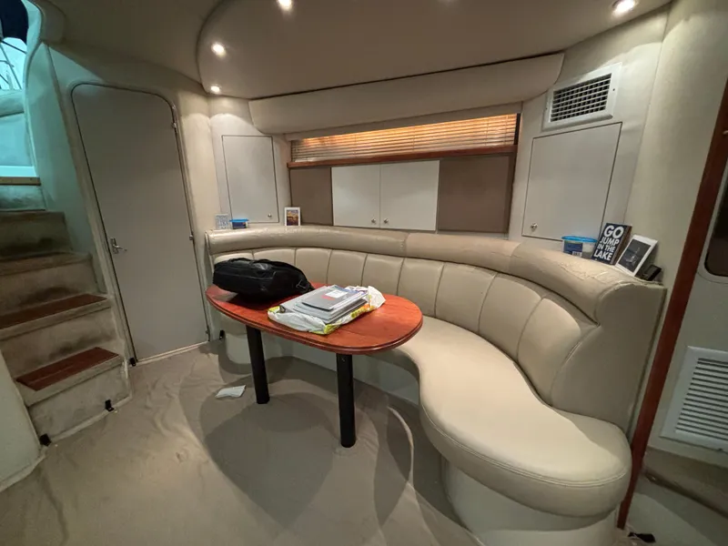 Slide: The Image of Interior of 1998 Cruisers Yachts 3870 Esprit with curved seating and table. - 14