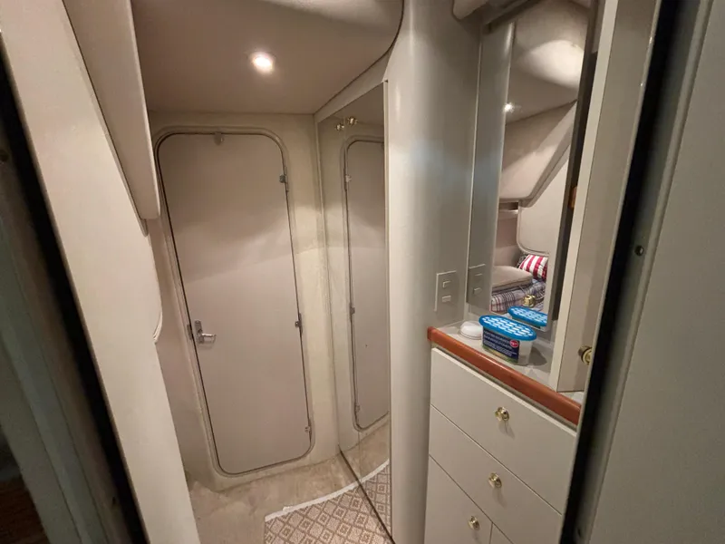 Slide: The Image of Interior of 1998 Cruisers Yachts 3870 Esprit, featuring hallway and storage cabinets. - 19