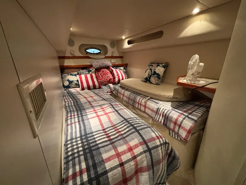 Slide: The Image of Cozy cabin interior of 1998 Cruisers Yachts 3870 Esprit with plaid bedding and decorative pillows. - 21
