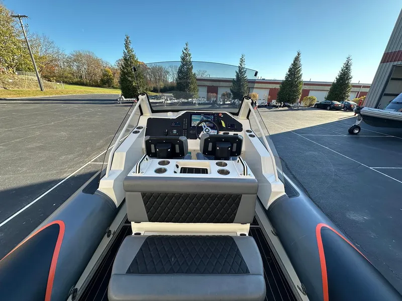 Slide: The Image of 2020 Sealegs 7.5 Semi Cabin boat dashboard with dual controls, parked outdoors. - 8