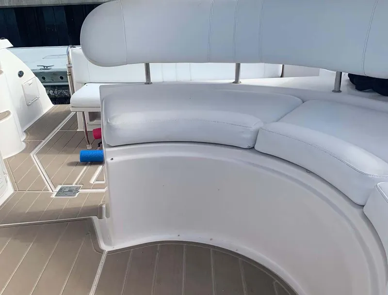 Slide: The Image of 2005 Regal Commodore 3560 boat interior with white seating and wood flooring. - 11
