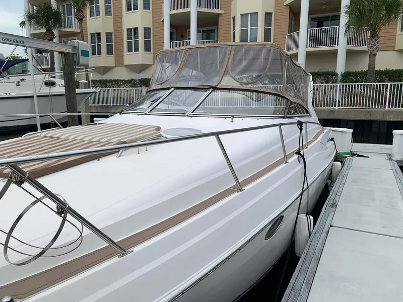Slide: The Image of 2005 Regal Commodore 3560 yacht docked near waterfront apartments. - 4