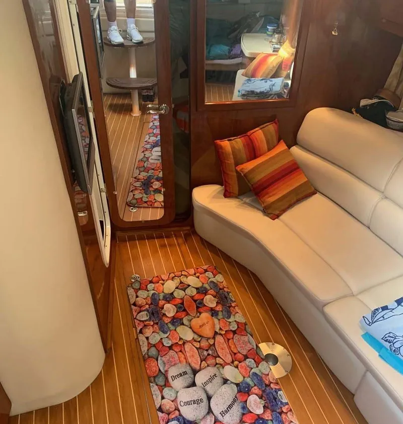 Slide: The Image of Interior of 2005 Regal Commodore 3560 yacht with cozy seating and colorful decor. - 7