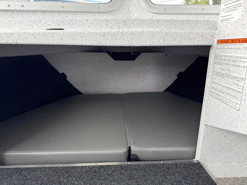 Slide: The Image of Interior cabin of 2025 KingFisher 2825 Coastal Express boat, featuring cushioned sleeping area. - 10