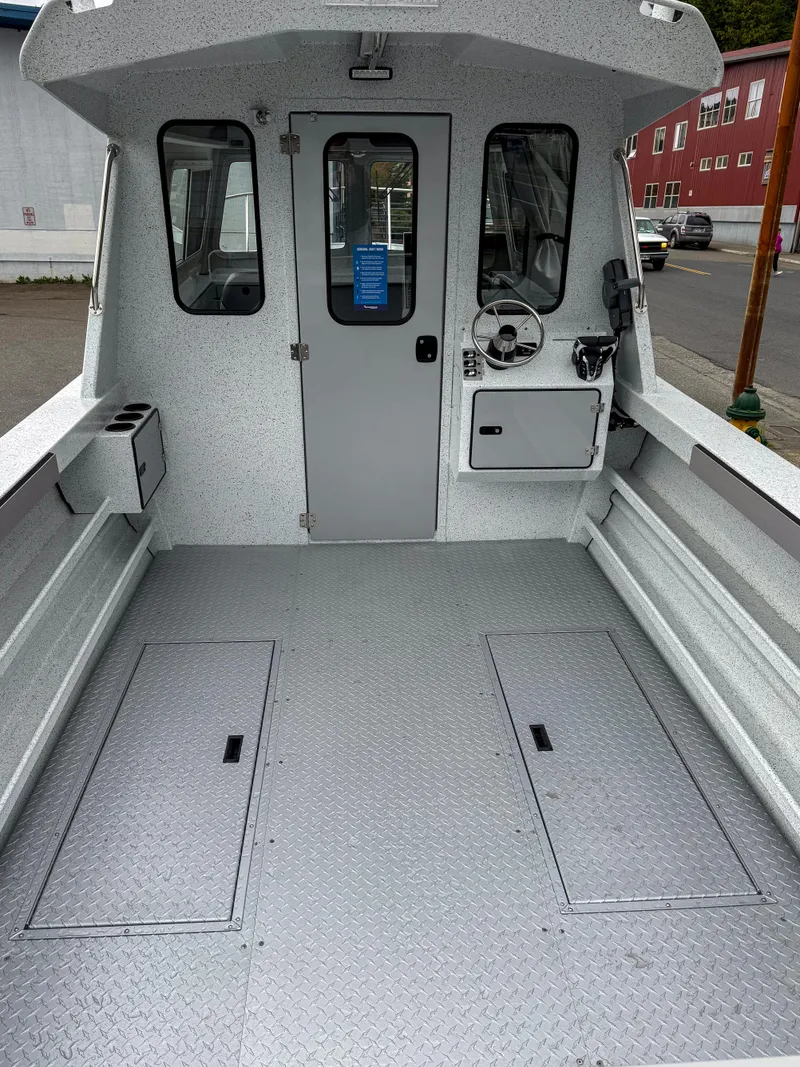 Slide: The Image of 2025 KingFisher 2825 Coastal Express boat interior with spacious deck and modern controls. - 11